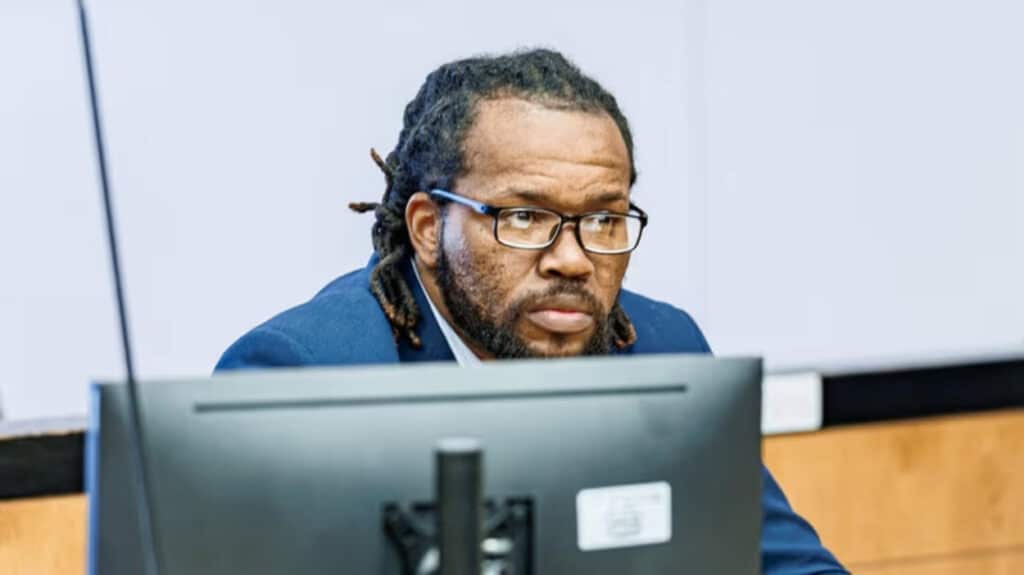 Mitchell Johnson listens to opening statements at his sex trafficking trial at the Cromarty Criminal Court in Riverhead this month. Credit Michael A. Rupolo Sr.